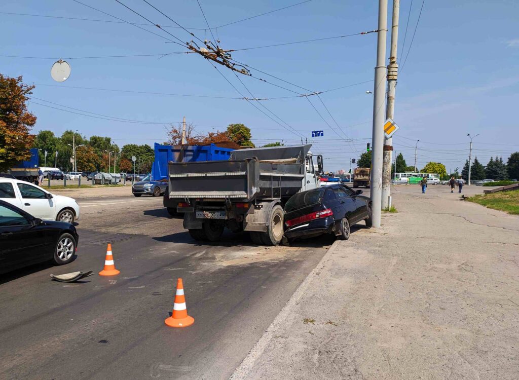 Dump truck involved in a hit-and-run crash in West Palm Beach causing severe damage to a passenger vehicle near a roadway intersection