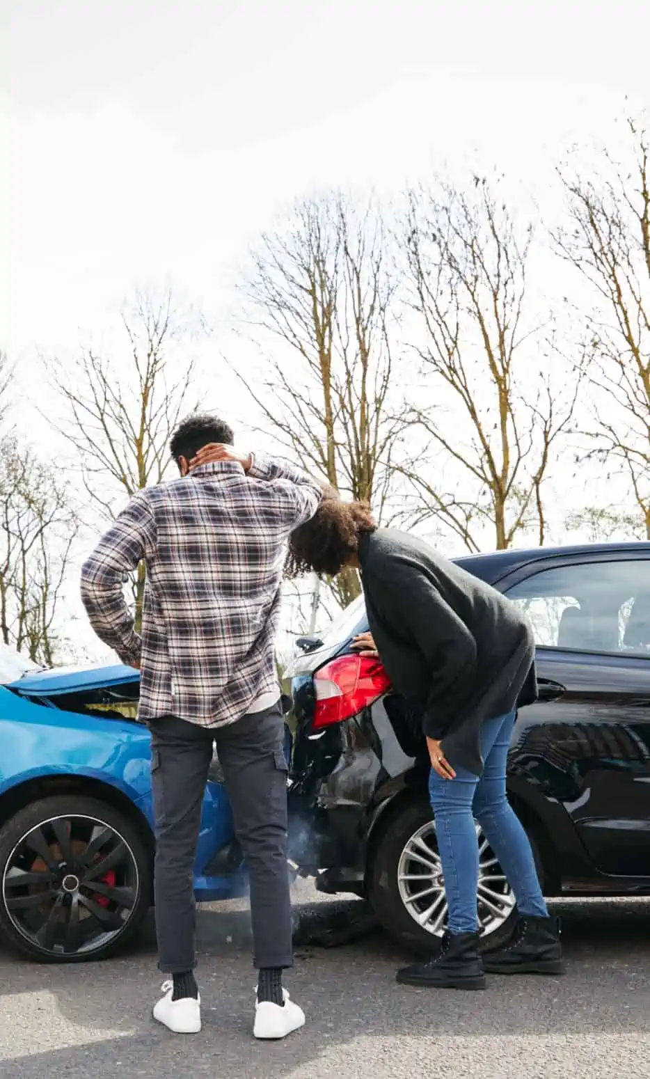 Man & Woman Checking Their Cars After Accident | Felice Trial Attorneys