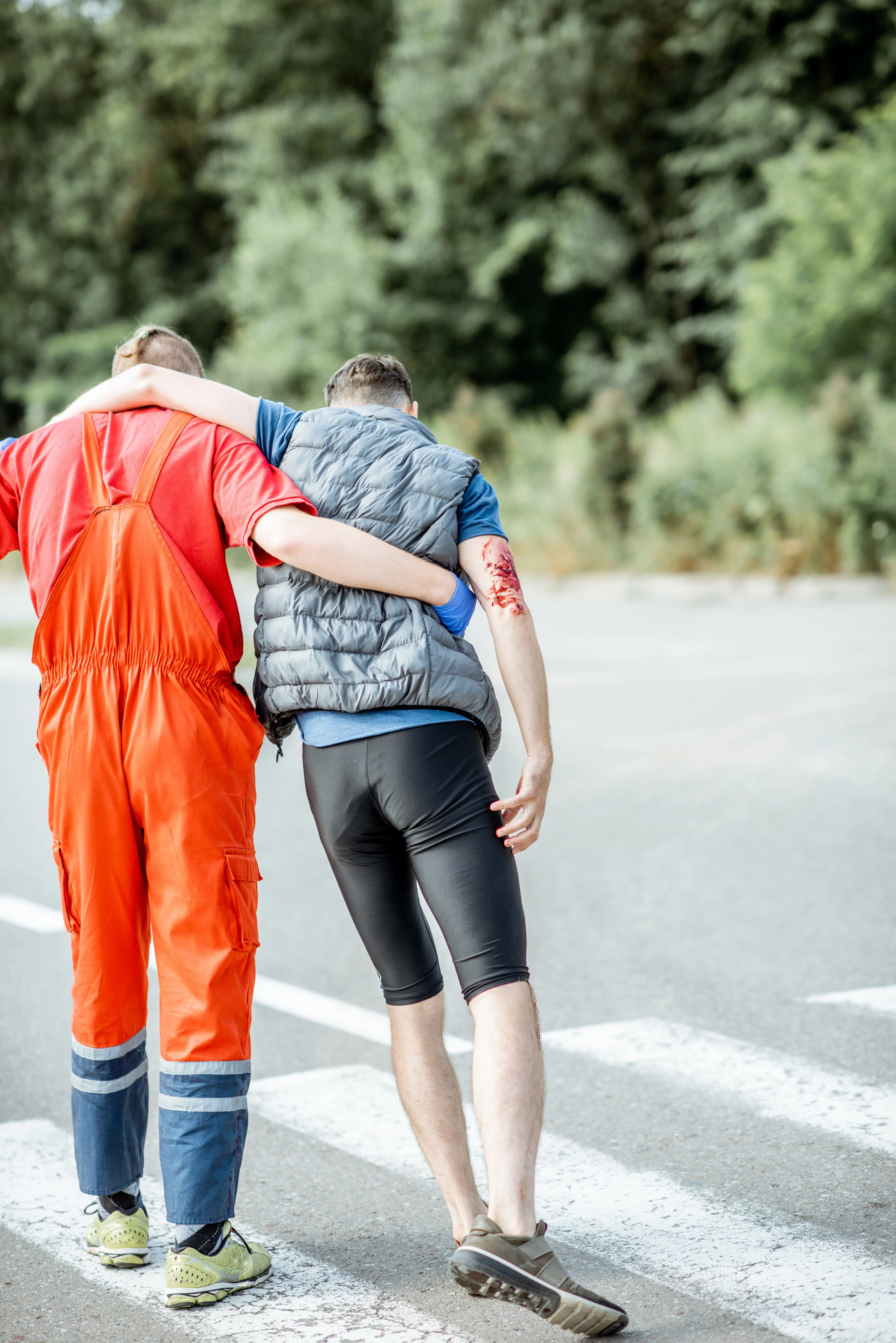 Medic walking with injured man after the accident