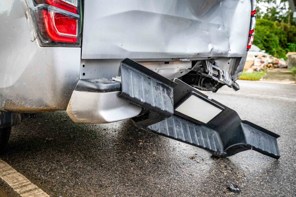 A damaged rear bumper of a vehicle after a rear end accident highlighting do I need PIP insurance in Florida.