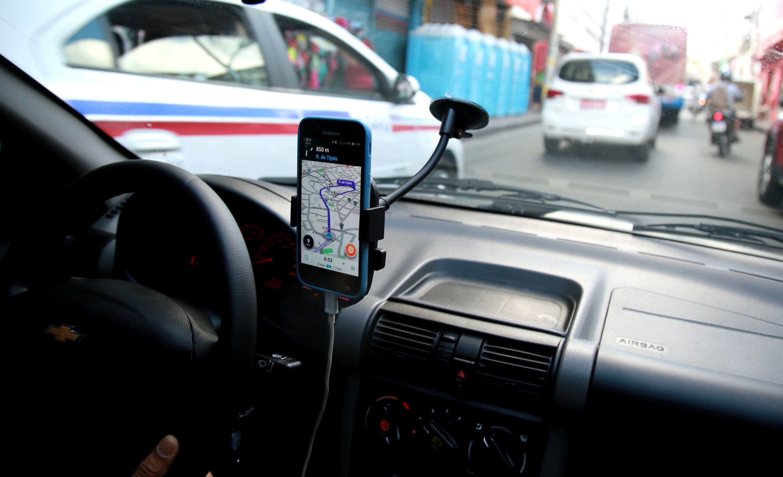 Driver using a rideshare navigation app in traffic, representing legal claims handled by West Palm Beach rideshare accident attorneys after Uber or Lyft crashes