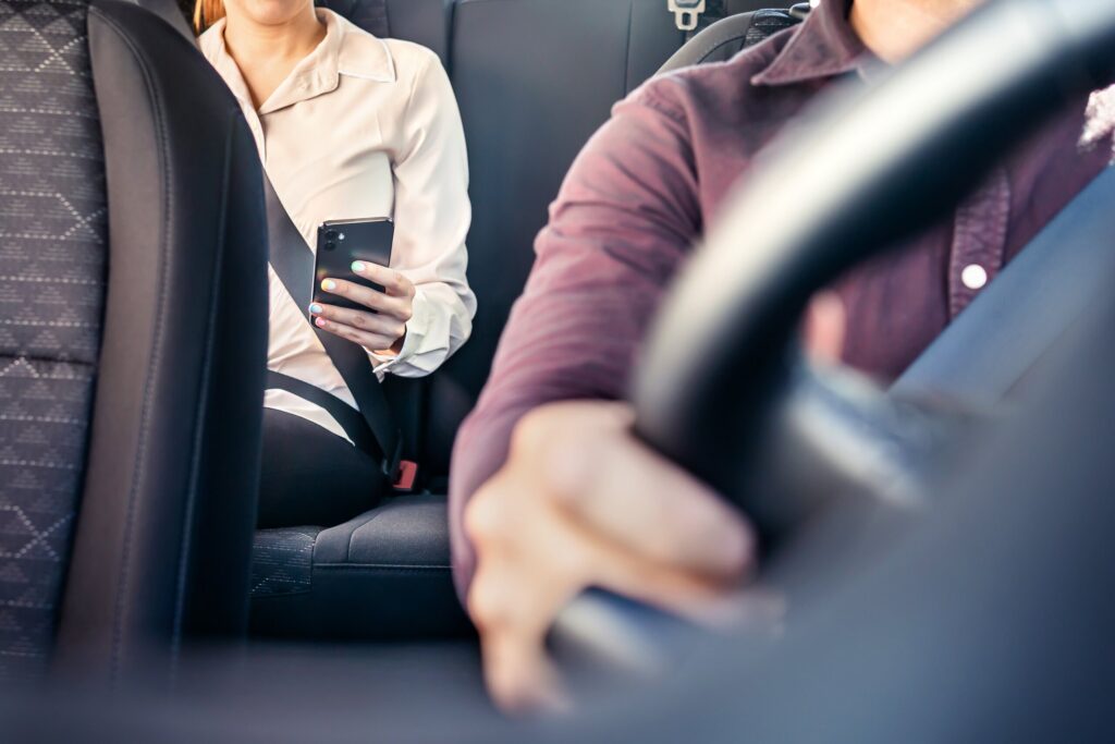 A passenger riding in the backseat of a vehicle highlighting services from Boca Raton Rideshare Accident Attorneys.