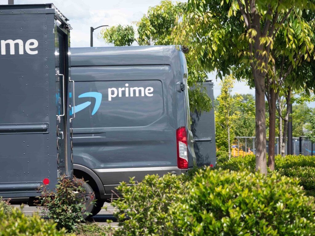 Amazon Prime delivery vehicles parked outdoors representing options if you can sue Amazon if a delivery driver hit you in Florida.