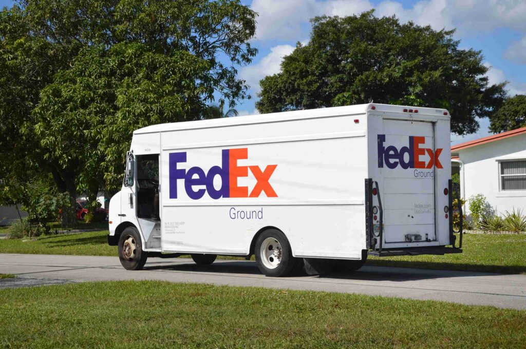 A FedEx Ground delivery truck parked on a residential street addressing who is liable when a FedEx truck hits you in Florida.