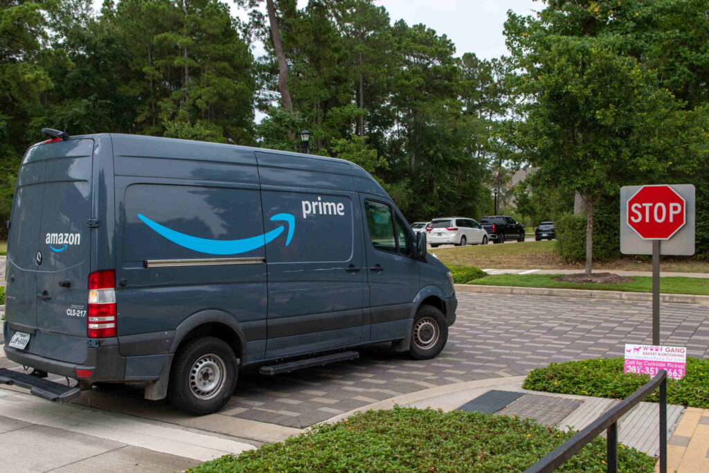 Amazon Prime delivery van stopped near a stop sign illustrating Amazon truck accident settlements in Florida what to expect.
