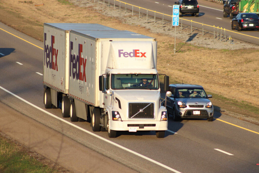 FedEx Freight semi truck driving on a highway illustrating FedEx truck accident settlement amounts in Florida what to expect.