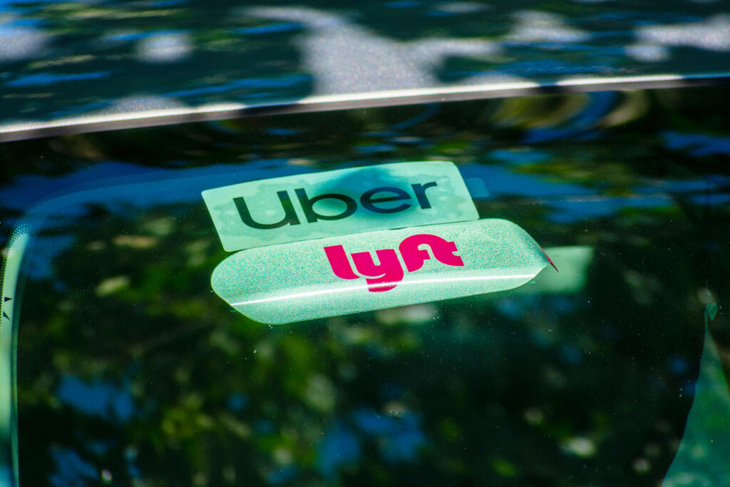 Uber and Lyft stickers on a car windshield explaining what happens if your Uber or Lyft driver gets in an accident in Florida.